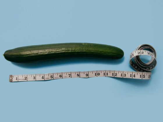 A cucumber representing the average penis size with a tape measure next to it