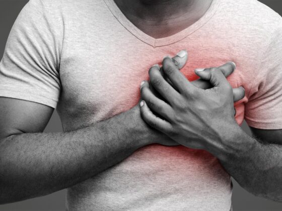 man having heart ache, holding hand on chest