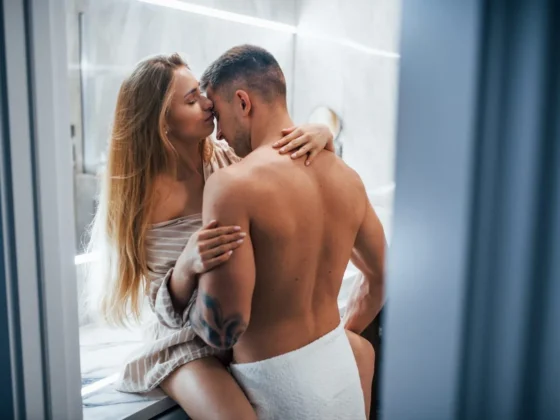 Young couple embracing and kissing each other in the bathroom